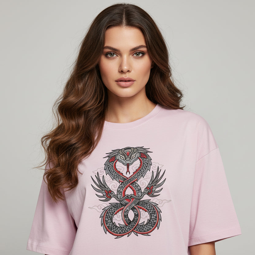 Woman wearing a pink t-shirt with a snake design on a plain background