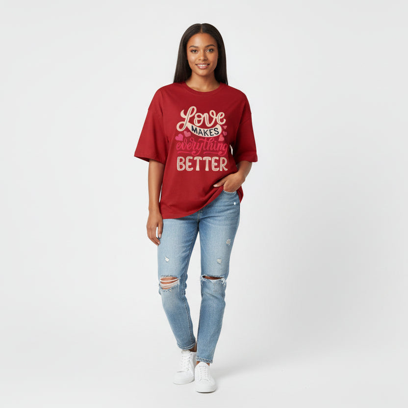 Person wearing a red t-shirt with text and light blue jeans on a white background