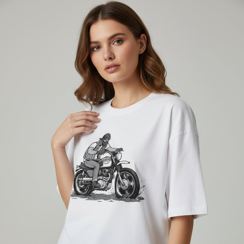 Woman wearing a white t-shirt with a graphic of a person on a motorcycle.